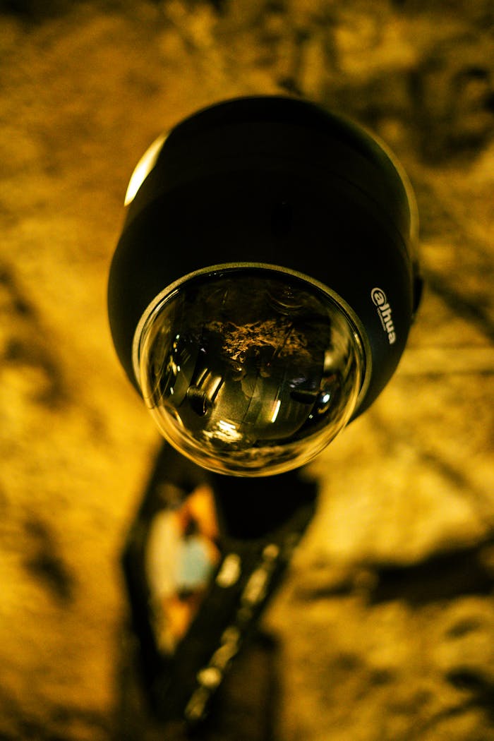 gallery-1 Detailed close-up image of a security surveillance camera lens indoors.